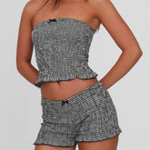 Women's black plaid smocked tube top and matching shorts set.